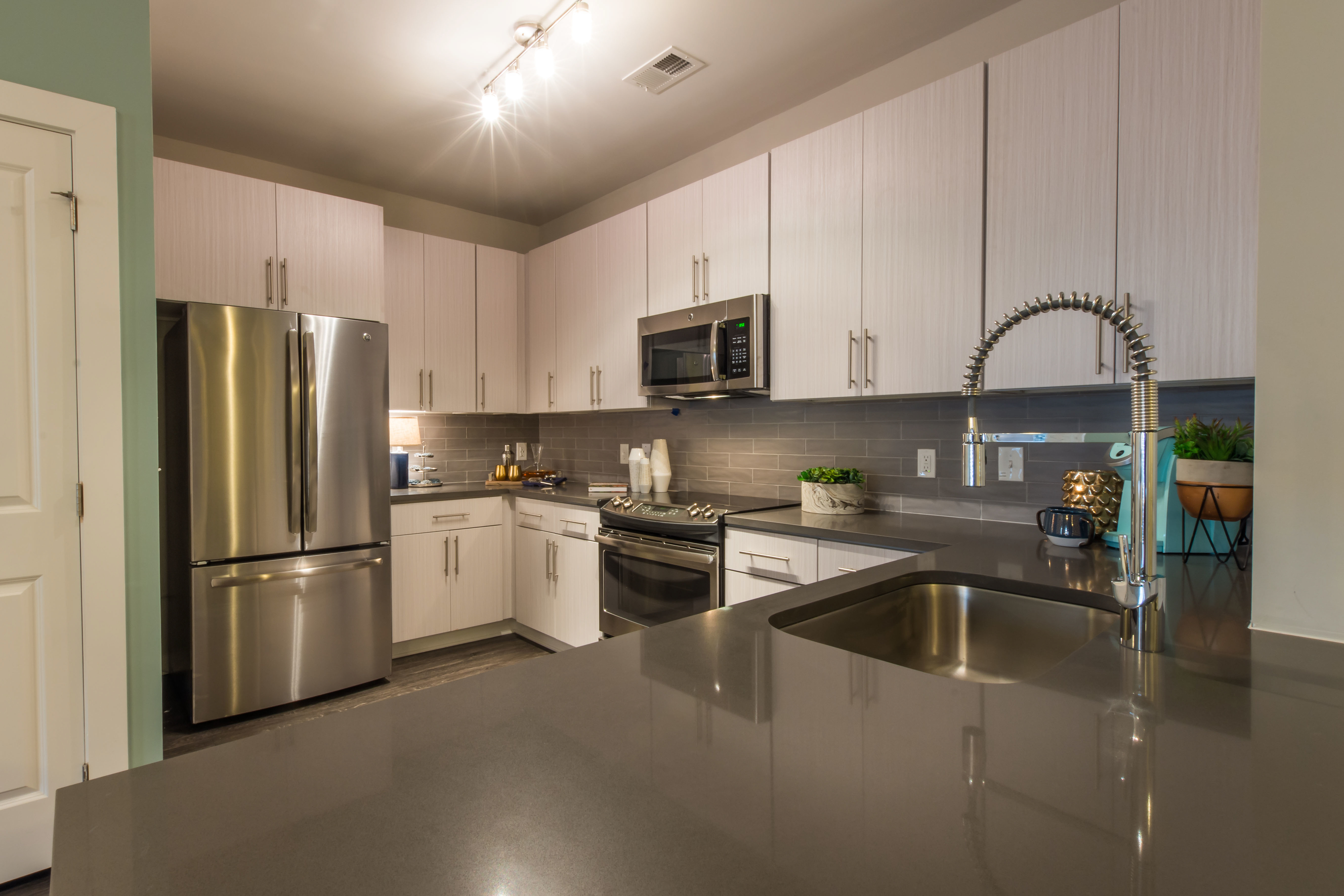 a kitchen with stainless steel appliances and white cabinets